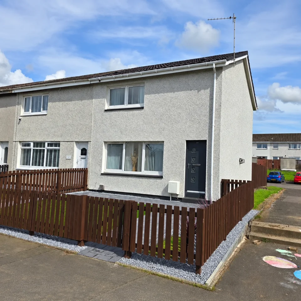 Light roughcast finish across the front of a terraced house